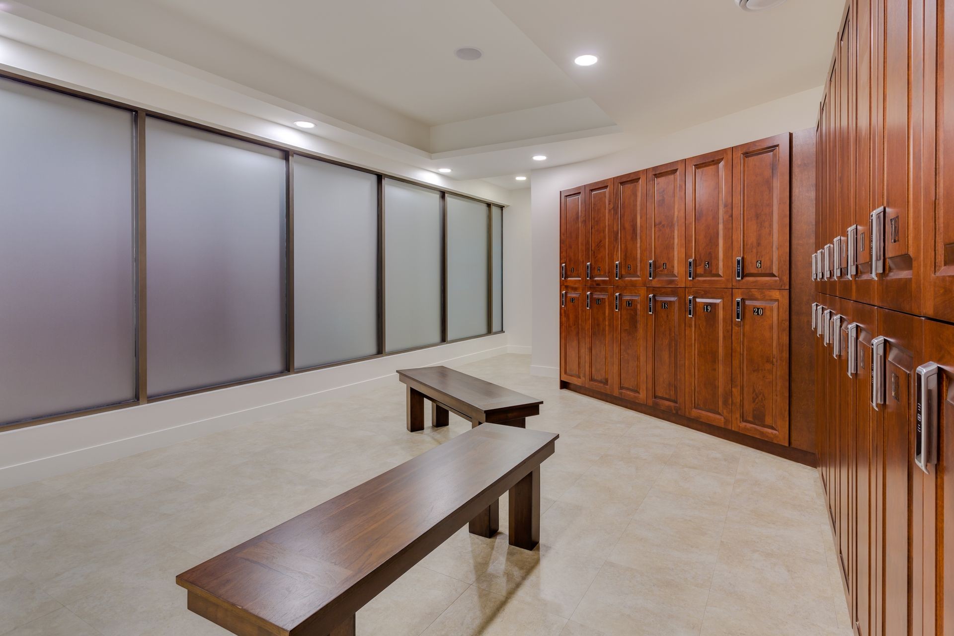 Newly built modern dressing room with lockers and benches for sitting.